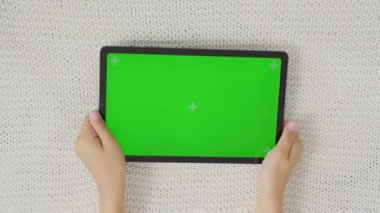 Çocuğun elini tut ve yatay yeşil ekranla tablet bilgisayara vur. Model. 