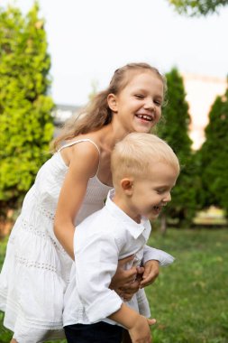 Children run, have fun and play. Boy and girl. Focus on the face of the children.