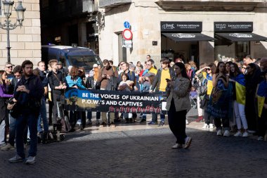 Poster at a meeting in support of Ukrainian with the inscription be the voice of ukraine p.o.w.s and captives. 1000 days of war. Rally of Ukrainians in Barcelona Spain 25.11.2024 clipart