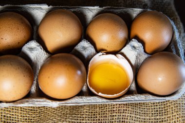 Kırık yumurta sarısını gösteren kahverengi yumurtalar.