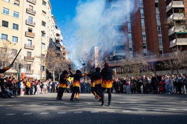 people dressed as fire dragons light torches with fire in the streets. Catalan traditions . The Chinese celebrate Chinese New Year in Spain, Barcelona 25.01.2025 clipart