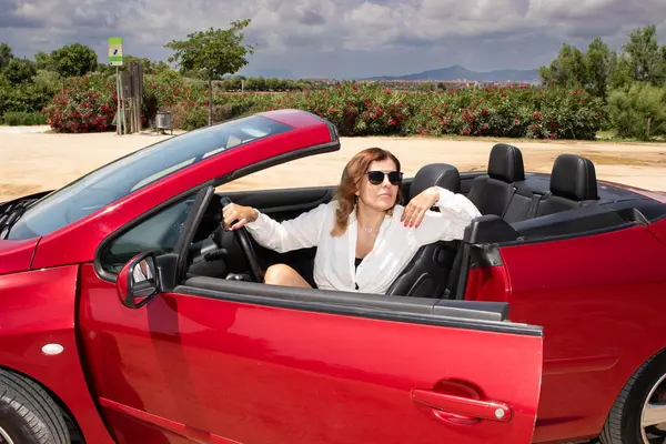 Araba gezisi, kadın sürücü üstü açık kırmızı araba.