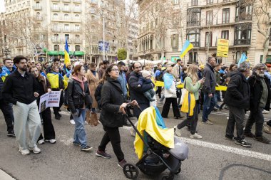 Ukrayna 'da 3 yıl süren savaşın onuruna Katalonya sokaklarında posterleri ve bayrakları olan Ukrayna gösterileri. Ukraynalıların Barselona 'daki mitingi 23.02.2025