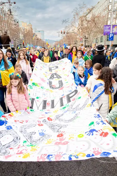 Ukrayna gösterisindeki çocuklar, Ukrayna 'da 3 yıl süren savaşın onuruna Katalonya sokaklarında posterler ve bayraklarla gösteri yaptılar. Ukraynalıların Barselona 'daki mitingi 23.02.2025