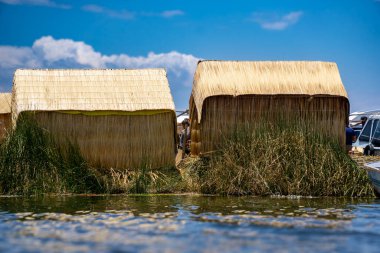 Floating Villages of the Uros People on Lake Titicaca, Peru with Traditional Reed Houses and Stunning Reflections in the Water clipart