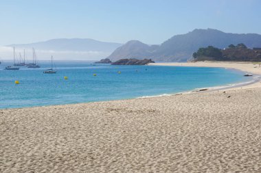 Atlantik Okyanusu 'nun Kristal Berrak Turkuaz Suları' nda yelkenli tekneleriyle Cies Adaları Sahili Manzarası