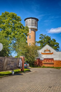 Kuldiga. A water tower is an elevated structure that supports a water tank.