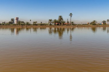 Menara gardens reflecting pool and pavilion with the snow capped Atlas mountains in the background, Marrakech, Morocco. clipart