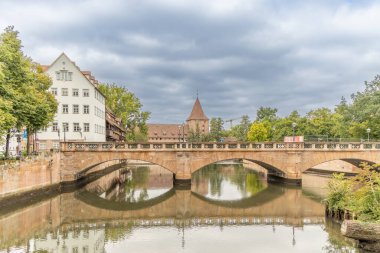 Maxbrucke or Maxbruecke is an arch bridge over the Pegnitz river in the old town of Nuremberg. Nuremberg is the second largest city of Bavaria state in Germany. clipart