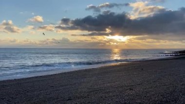 sunset beach waves lapping on sand calm and relaxing - stock footage video - Hastings St.Leonards beach East Sussex UK