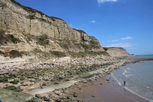 Hastings Cliff at Rock-a-Nore. Rising sea levels are undermining the huge sandstone cliffs to the east of Hastings. Parts of the coast including housing estates are threatened.