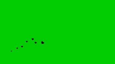Animasyon kara kalpler soldan sağa uçar. Uçan kalpler dalgası. Vektör illüstrasyonu yeşil arkaplanda izole edildi.