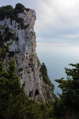 Amazing view down to the sea from the mountain in Othonoi island, north-west of Corfu, Greece, at dusk clipart