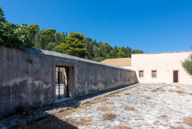 The fortress in Assos village, Kefalonia island, Greece, inside which there are the buildings of the abandoned prison  clipart