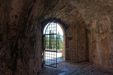 The fortress in Assos village, Kefalonia island, Greece, inside which there are the buildings of the abandoned prison  clipart