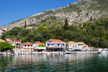 August 18th 2023 - Kalamos island, Greece - The beautiful harbor village in Kalamos island, Greece, with taverns and fishing boats clipart