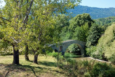 Amazing scenery by the river near Ziakas old stone bridge, Grevena, Greece clipart