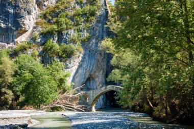 Amazing scenery in Portitsa canyon, near Spilaio village, Grevena, Greece, where there is an old arc bridge  clipart