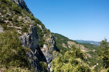 Amazing mountainous scenery near Spilaio village, Grevena, Greece, with an adventurous road perfect for motorcycles clipart