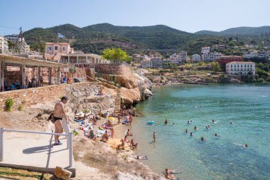 June 25th 2024 - Aidipsos, Greece - The waterfront of Aidipsos, a Greek town in North Evia famous for its hot springs and spas, with lots of people enjoying the free warm water spa clipart