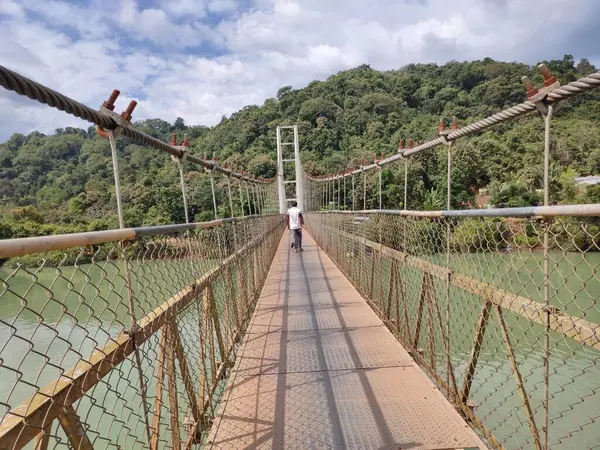 A man crossing over the Foot Bridge