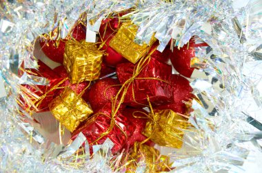 Noel kompozisyonu, kırmızı toplar ve gümüş süslemeli sarı hediyeler.