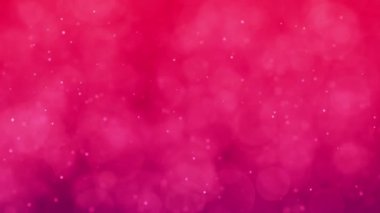 Yüzen parçacıkların olduğu yumuşak pembe bir bokeh arkaplanı.
