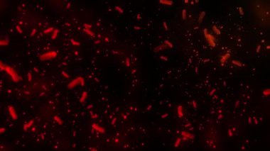 Turuncu bir arkaplanda yüzen altın kalp parçacıkları.