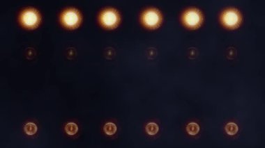 Yuvarlak, parlak, sarı ışıklardan oluşan bir duvar..