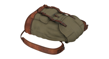 Deri kayışlı, engebeli bir sırt çantası. Açık hava maceraları ve seyahat için tasarlanmış..