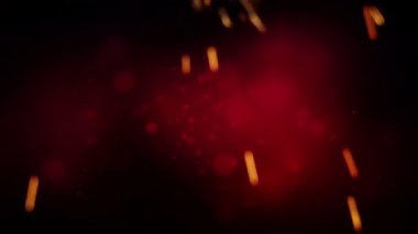 Karanlık bir arkaplan karşısında parçacıkların ve kıvılcımların yakın çekimi dramatik ve enerjik bir atmosfer yaratır..