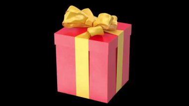 Canlı kırmızı bir hediye kutusu. Sarı kurdele ve yayla süslenmiş. Kutlamayı ve sürprizi simgeliyor..