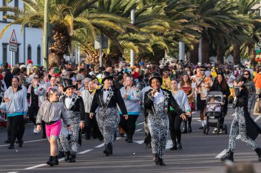 SANTA CRUZ DE TENERIFE, SPAIN - FEBRUARY 21, 2023: Coso parade - along the Avenida de Anaga, official end of Carnival. Again march carnival groups, floats, decorated cars and the Carnival Queens.