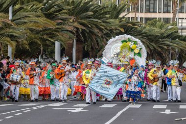 SANTA CRUZ DE TENERIFE, SPAIN - FEBRUARY 21, 2023: Coso parade - along the Avenida de Anaga, official end of Carnival. Again march carnival groups, floats, decorated cars and the Carnival Queens.