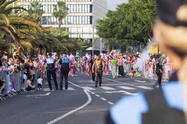 Santa CRUZ DE TENERIFE, İspanya - 13 Şubat 2024: The Coso geçidi, Cavalcada - Avenida de Anaga boyunca, Karnaval 'ın resmi sonu. İnanılmaz sıcak bir akşam, karnaval kostümlü neşeli insanlar eğleniyor..