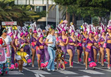 Santa CRUZ DE TENERIFE, İspanya - 13 Şubat 2024: The Coso geçidi, Cavalcada - Avenida de Anaga boyunca, Karnaval 'ın resmi sonu. İnanılmaz sıcak bir akşam, karnaval kostümlü neşeli insanlar eğleniyor..