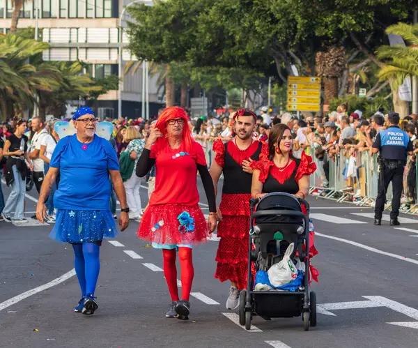 Santa CRUZ DE TENERIFE, İspanya - 13 Şubat 2024: The Coso geçidi, Cavalcada - Avenida de Anaga boyunca, Karnaval 'ın resmi sonu. İnanılmaz sıcak bir akşam, karnaval kostümlü neşeli insanlar eğleniyor..