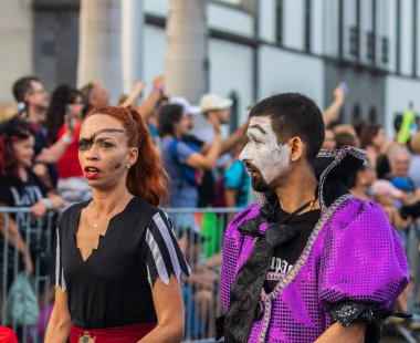 Santa CRUZ DE TENERIFE, İspanya - 13 Şubat 2024: The Coso geçidi, Cavalcada - Avenida de Anaga boyunca, Karnaval 'ın resmi sonu. İnanılmaz sıcak bir akşam, karnaval kostümlü neşeli insanlar eğleniyor..