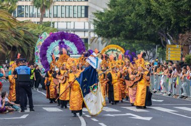 Santa CRUZ DE TENERIFE, İspanya - 13 Şubat 2024: The Coso geçidi, Cavalcada - Avenida de Anaga boyunca, Karnaval 'ın resmi sonu. İnanılmaz sıcak bir akşam, karnaval kostümlü neşeli insanlar eğleniyor..
