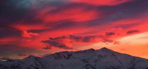 colorful sunset over the mountains, the sun rises in the sky with clouds, the concept of the weather