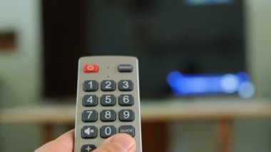 Man browse smart tv app,zapping channels on leisure time,home tech lifestyle.
