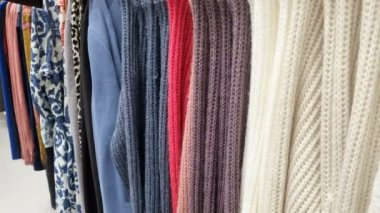 Fashion woman choosing shirt in a retail shopping center mall, clothing store industry.4k