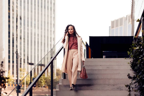 stock image elegant accountant lady walking down the stairs - female lawyer speaking on phone call in downtown