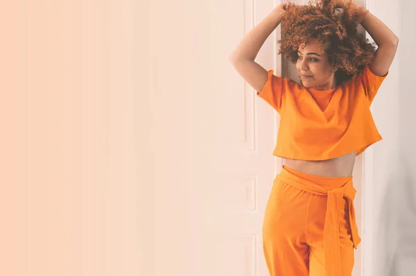 Fashionable Curly Hair African American Lady Orange Outfit Looking Away Imagini stoc fără drepturi de autor