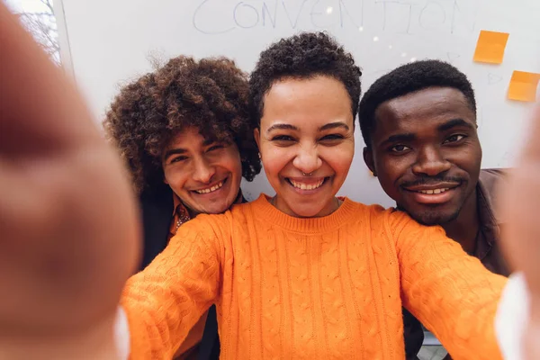 Three Happy Multiethnic Friends Taking Selfie Together Workplace Young Colleagues Imagen de archivo