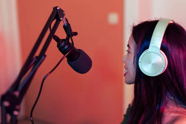 Empowering Voices: Asian Woman Smiling while Podcasting