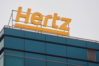 Bucharest, Romania - January 13, 2023: The logo of the American car rental company Hertz can be seen on a building. This image is for editorial use only.