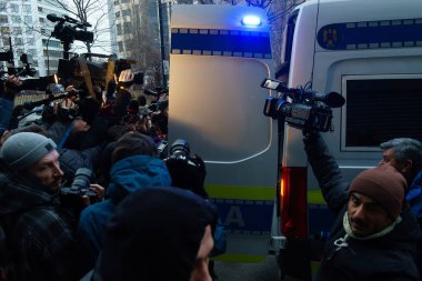 Bucharest, Romania - January 25, 2023: Journalists crowd to see Tate brothers in the car that takes them to prison at the Directorate for Investigating Organized Crime and Terrorism DIICOT.