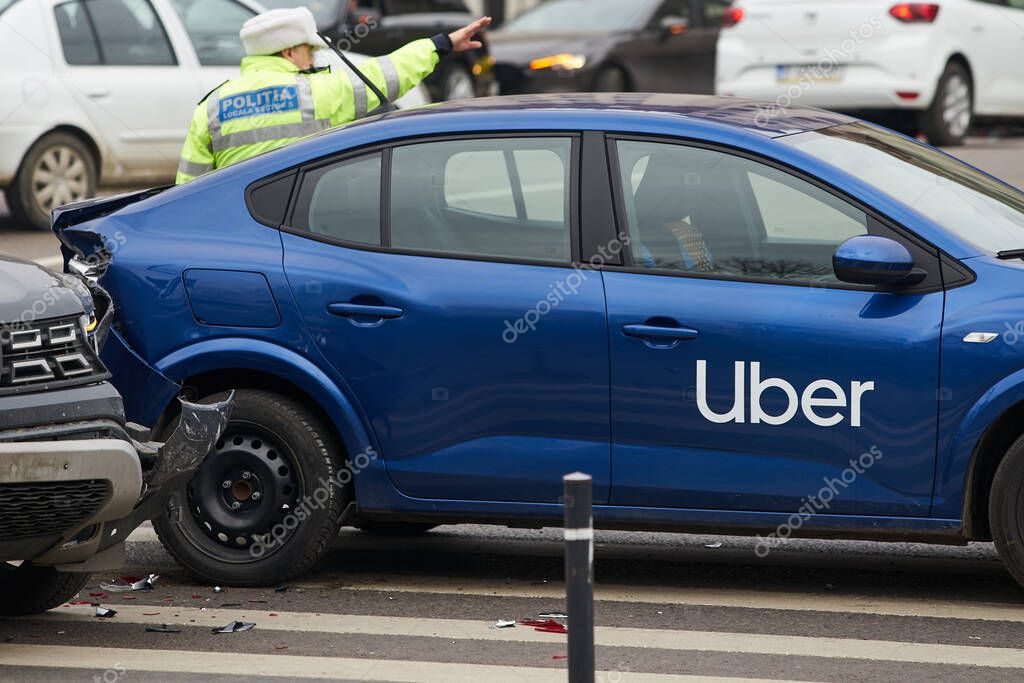 Bucharest, Romania - March 02, 2023: An Uber logo branded car on the road at the place where it was involved in a car accident. This image is for editorial use only.