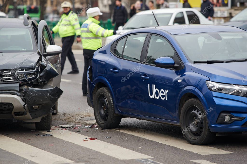 Bucharest, Romania - March 02, 2023: An Uber logo branded car on the road at the place where it was involved in a car accident. This image is for editorial use only.